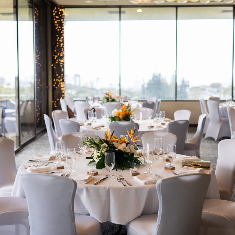 Photo of an empty wedding reception space with the tables all set for the reception.